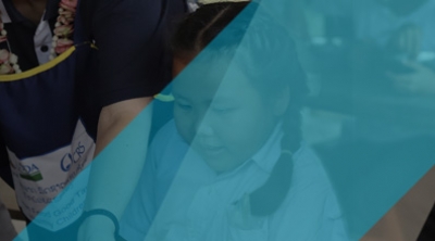 Two school children hugging each other.