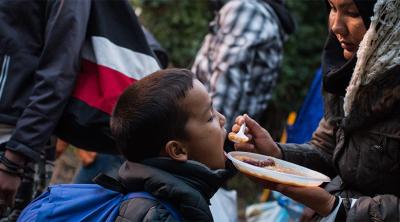 Refugees from Syria and Afghanistan cross the border from Serbia.