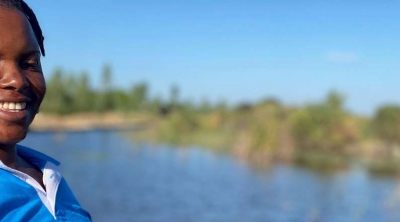 woman smiling near reservoir in Zimbabwe 