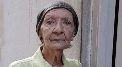 woman standing outside near a door in Cuba