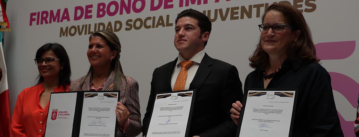 CRS staff and officials from Nuevo León stand with official documents for the Social Investment Bond partnership