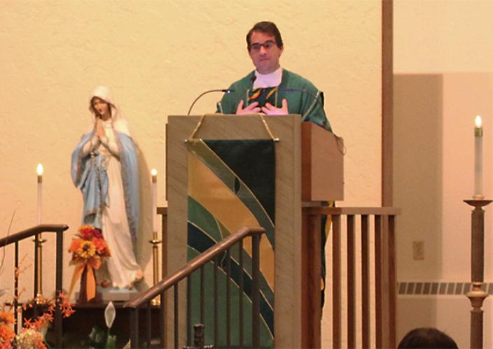 priest in green garment at lecturne