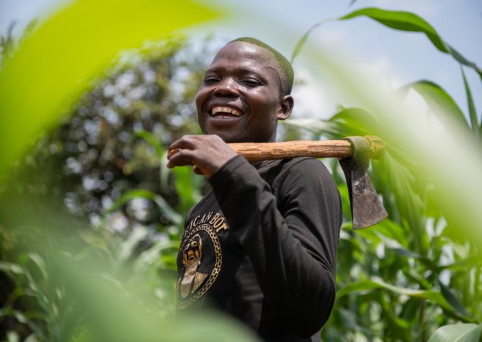 A man holding a farming tool.