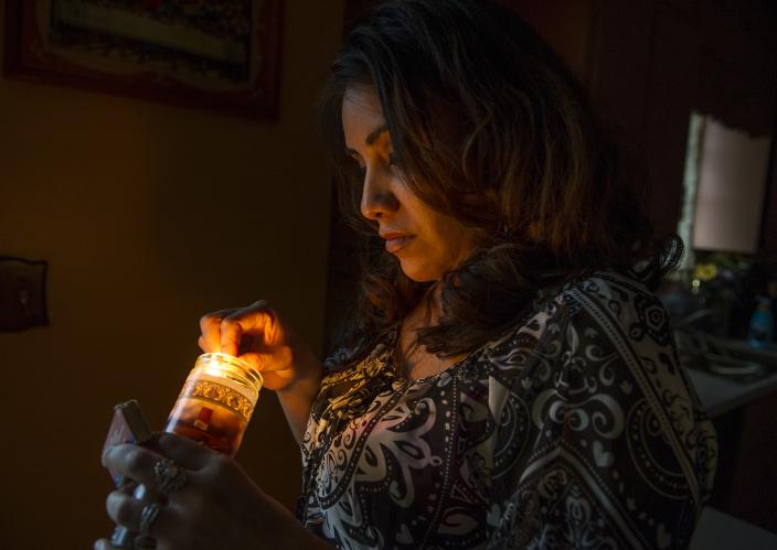 woman holding votive candle
