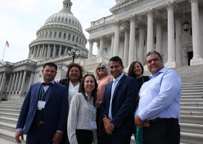 group stands outside Capitol building