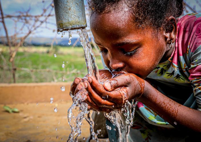 girl drinking water in Ethiopia