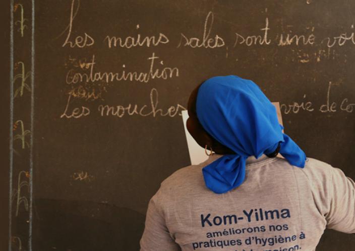 A woman looking at a school board.