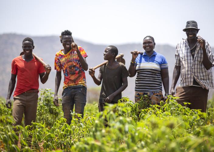 farmers laughing in a field