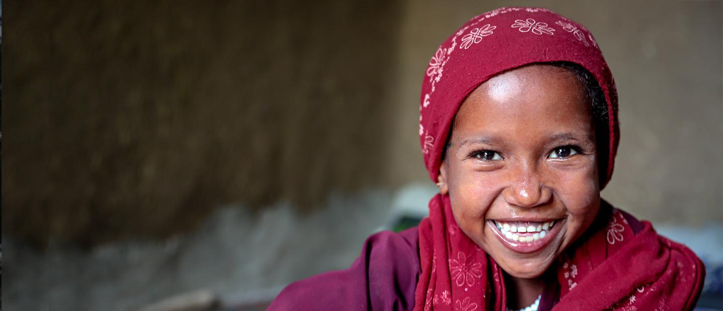 A child in red headscarf.
