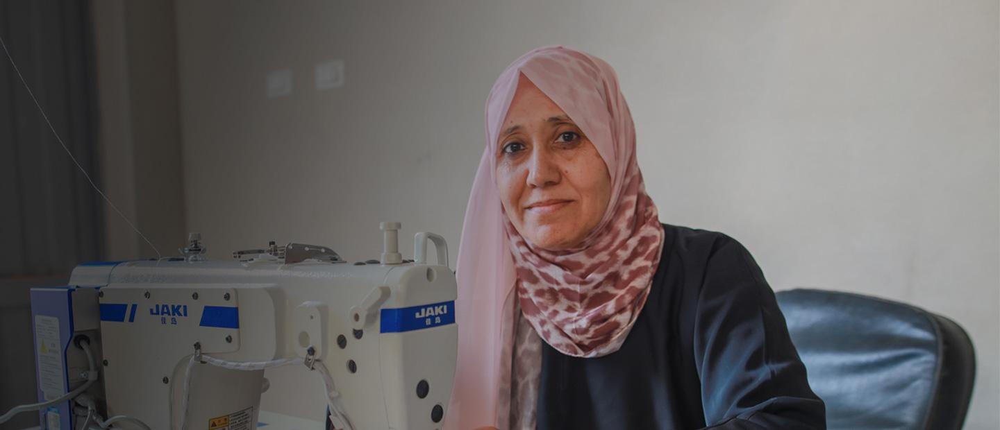 A woman by a sewing machine.