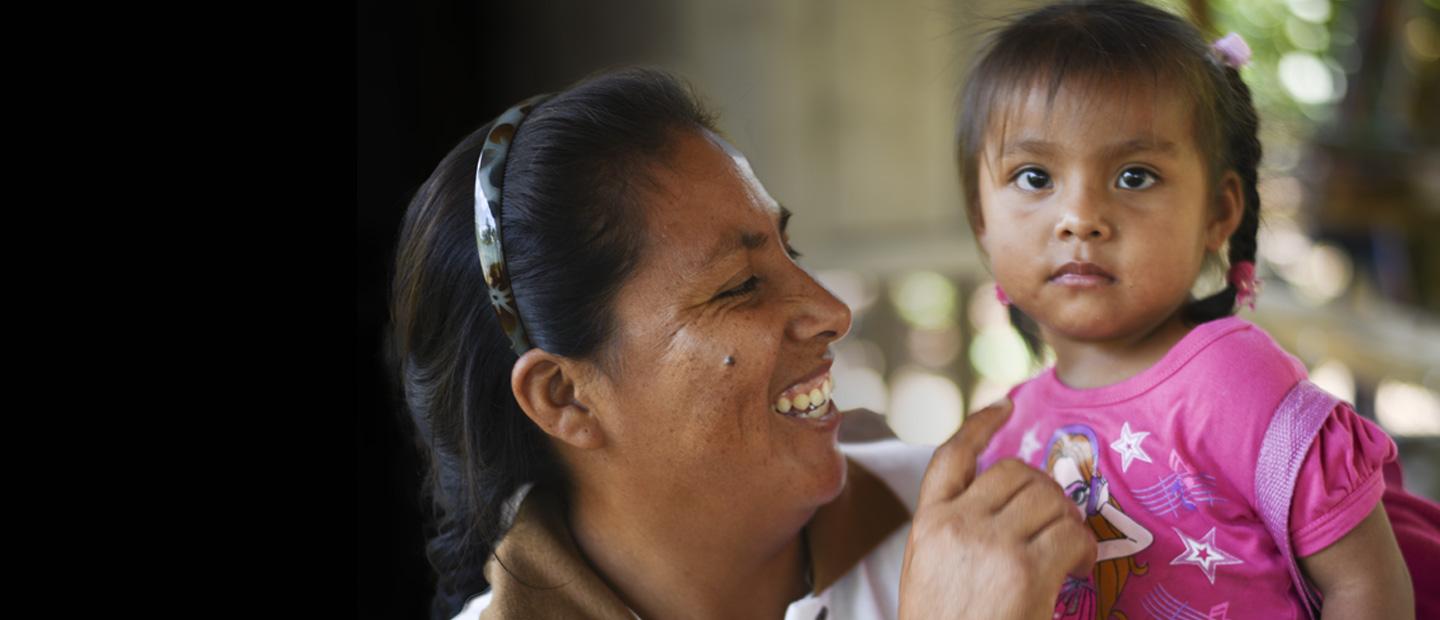 A woman carrying a child.