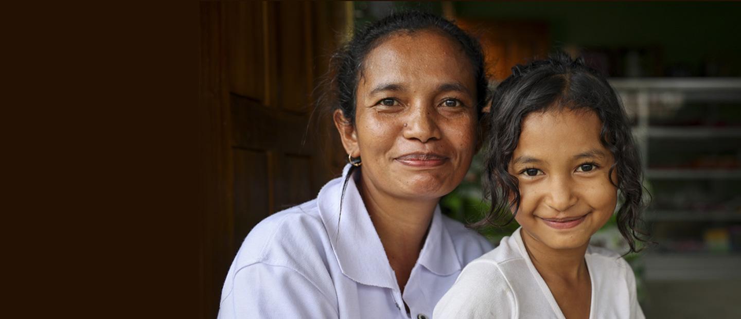 A woman and a child smiling.