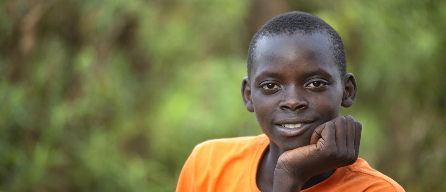 A young boy in orange t-shirt.