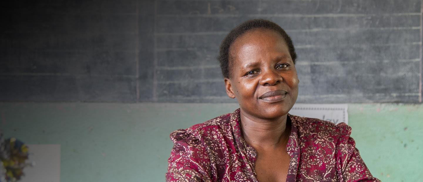 A woman in front of a classroom board.