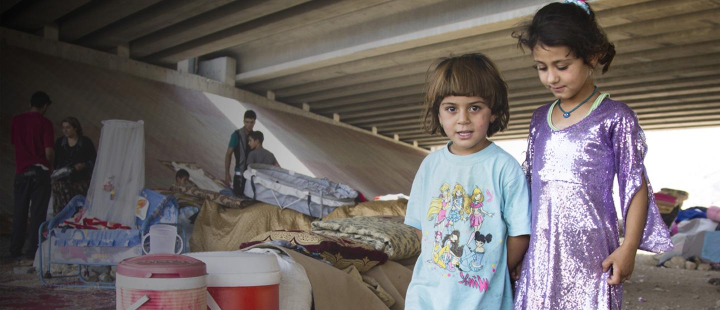 2 children under a bridge.