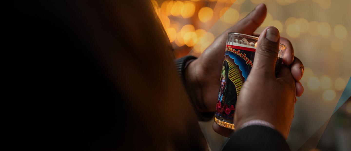 hands holding a lit candle