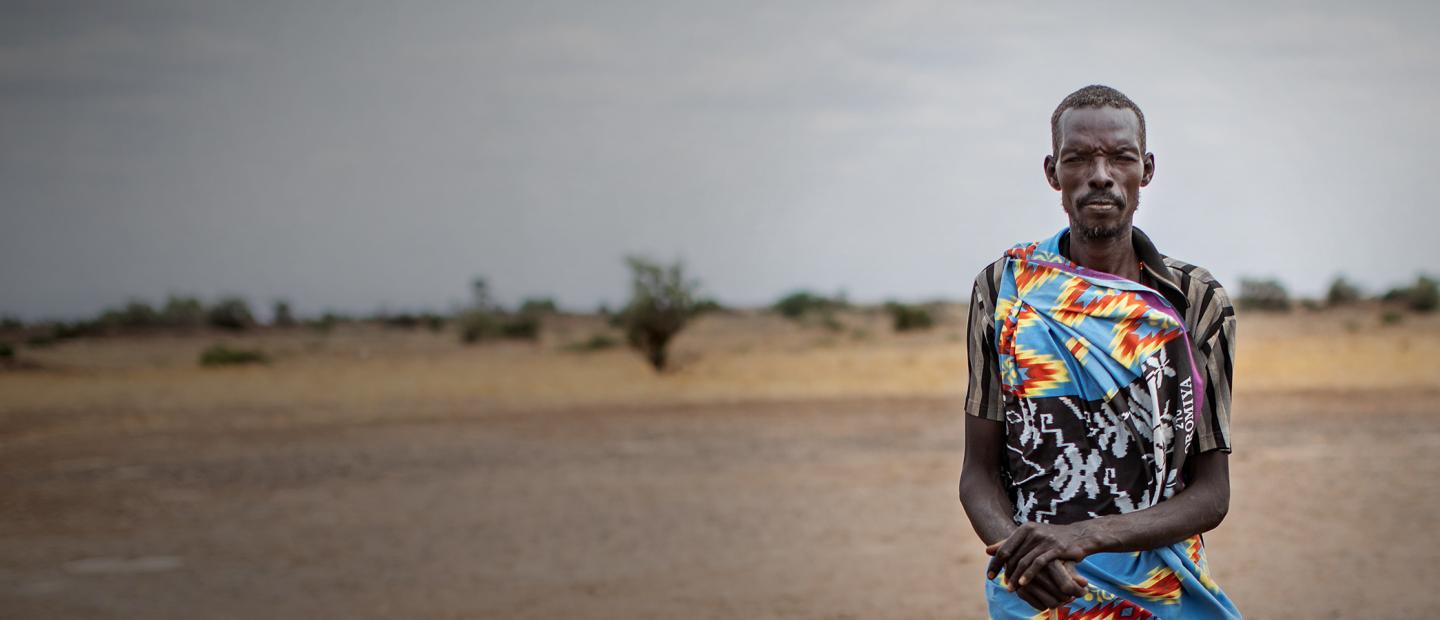 portrait of man in front of dry land