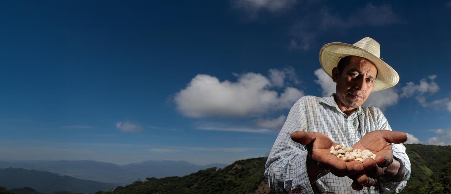 farmer holding produce harvested from his farm