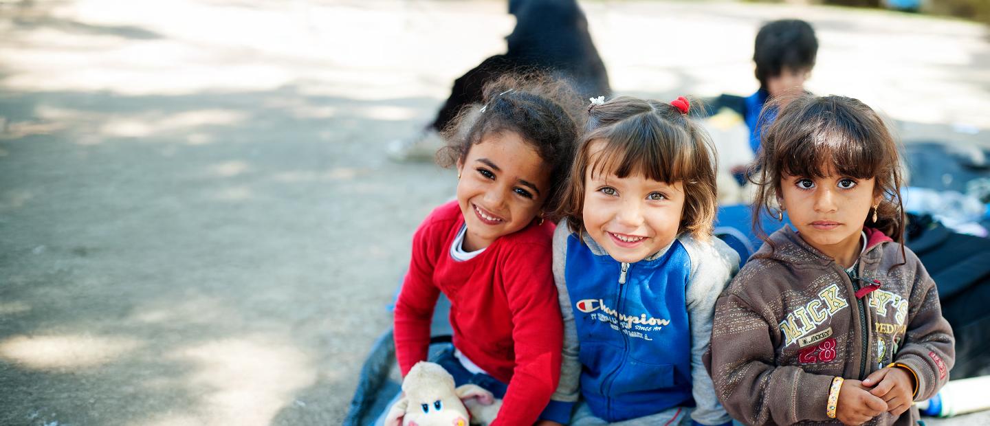 three young girls smiling together