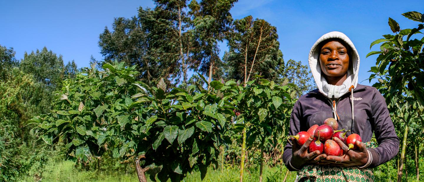 woman in field holding produce