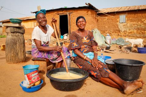 Women make shea butter soap outside in Gando Village, Benin.