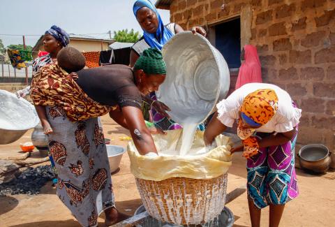 Members of the Nonkannera SILC group strain liquid from a soy cheese mixture.