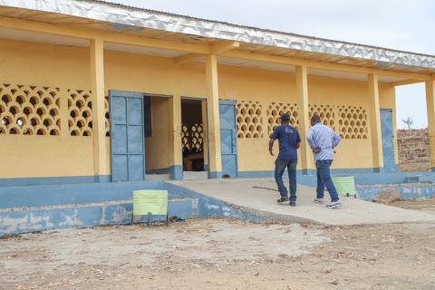 caretakers enter a school building in Cameroon