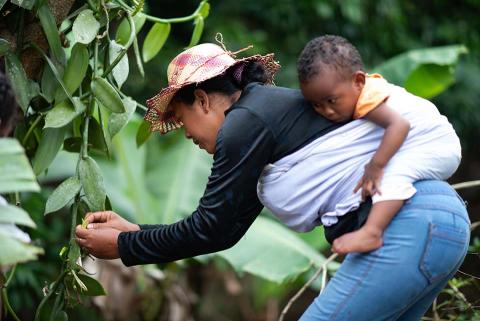 Woman with a child on her back.