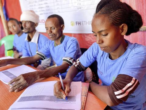 Workers at a distribution point where communities in Tigray receive food assistance.