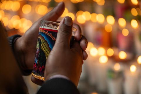 hands holding votive candle