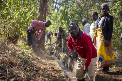 clearing debris from a canal in Malawi