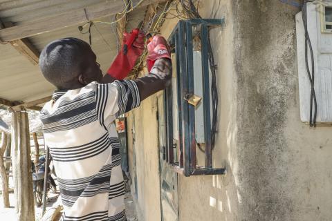 Pascal Deli fixes an electrical fault on a meter that supplies power to his and other shops.