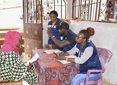 CRS Staff talking to a woman.