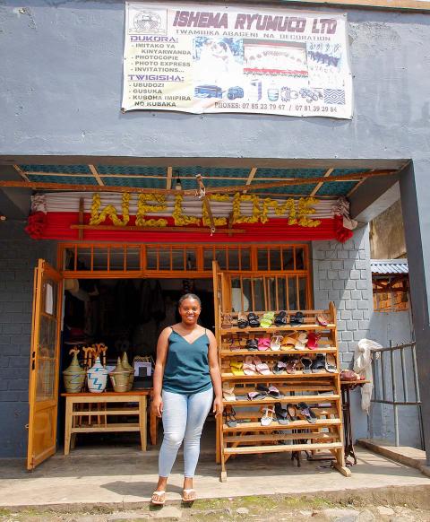 A woman standing in front of a store.