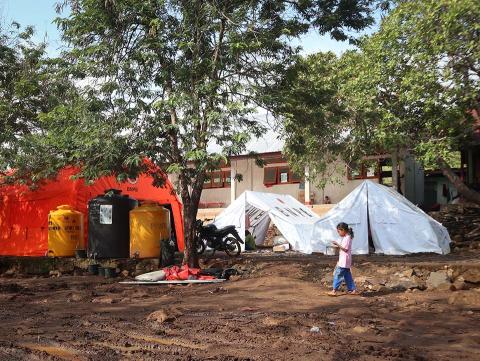 A girl in front of tents.