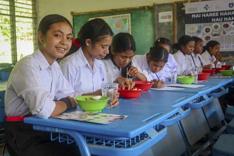Students eating in a room.