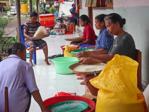 Women holding rice trays.