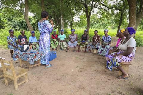 A group of people sitting around a circle.