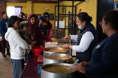 People in line to get food.