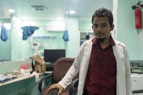 A man in white hospital jacket.