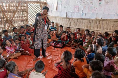 Children sitting in a room.