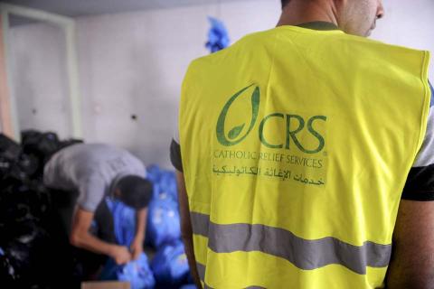 A CRS staff member standing in a supply room.