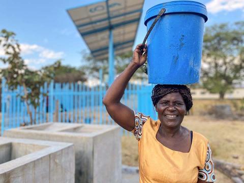 Woman with a bucket over her head.