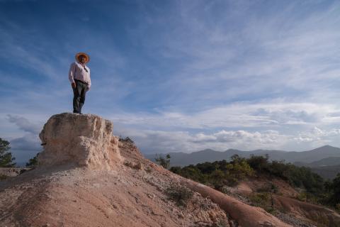 A man looking over a hill.