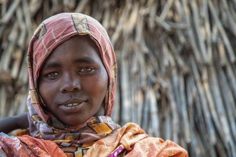 A woman in an orange headscarf.