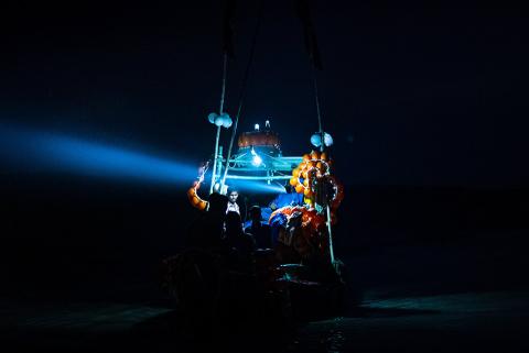 People on a boat in the dark.