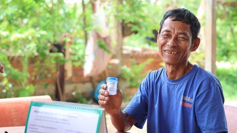 A man holding a test container.