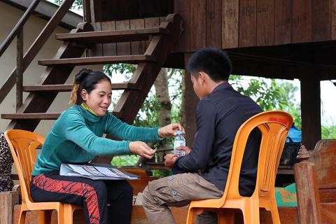 A woman and man sitting on chairs.