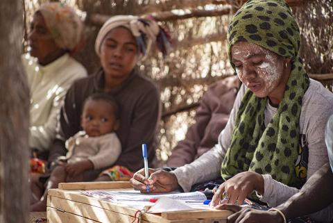 Woman writing in a notebook.