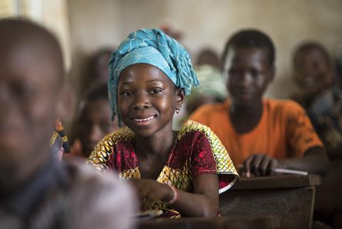 Children sitting at school desks.
